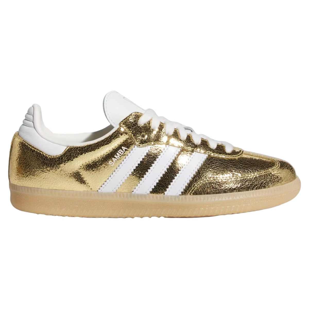 A metallic gold Adidas Gazelle sneaker with white leather stripes, white laces, and a beige gum sole, shown in a side profile on a white background.