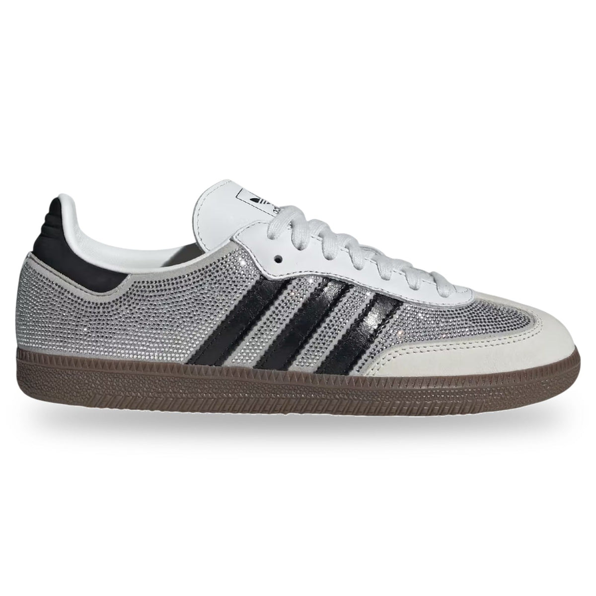 A low-top Adidas Samba sneaker featuring a silver rhinestone-embellished mesh upper, black three-stripes, a white leather toe cap and collar, and a brown gum sole, shown against a plain white background.