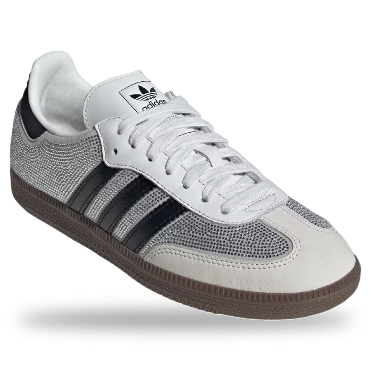 Gray and white Adidas sneaker with black stripes on a white background