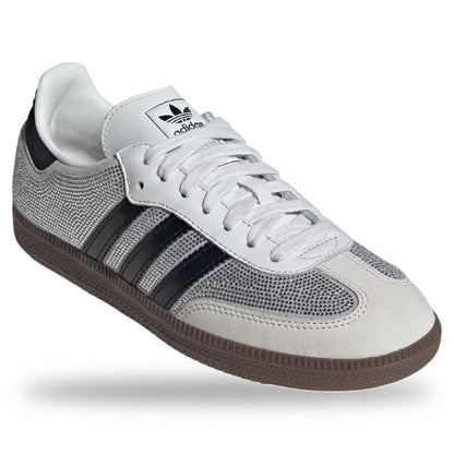 Gray and white Adidas sneaker with black stripes on a white background