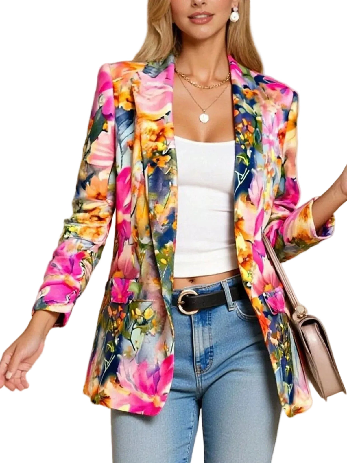 A woman wearing a vibrant, multicolor floral print blazer over a white crop top and blue jeans, holding a beige handbag against a solid beige background.