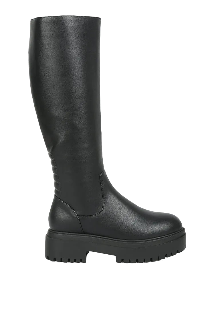 Black knee-high boot on a light gray background