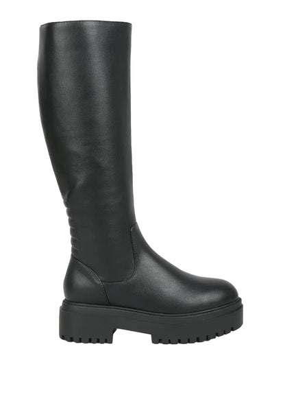 Black knee-high boot on a light gray background