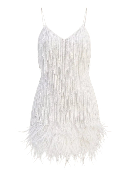 White fringed spaghetti-strap mini dress with a feathered hem, shown against a solid beige background.