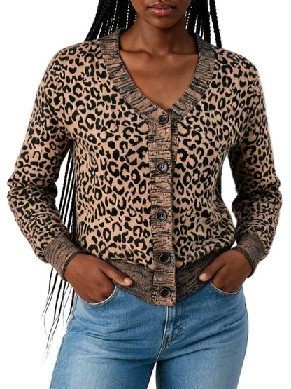 A woman wearing a beige and black leopard print cardigan with a V-neck and button-front closure, paired with blue jeans against a plain white background.