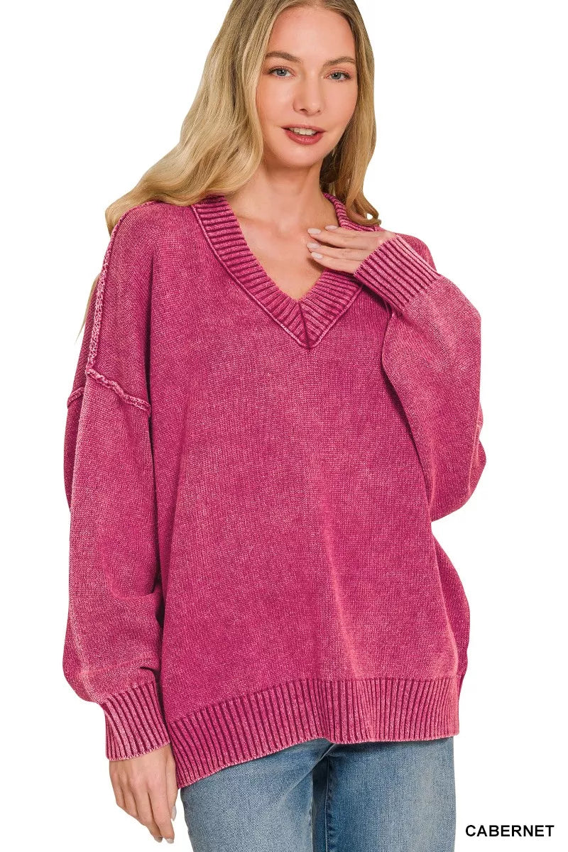 Woman wearing a pink sweater with a white background