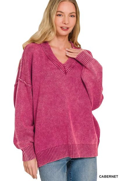 Woman wearing a pink sweater with a white background
