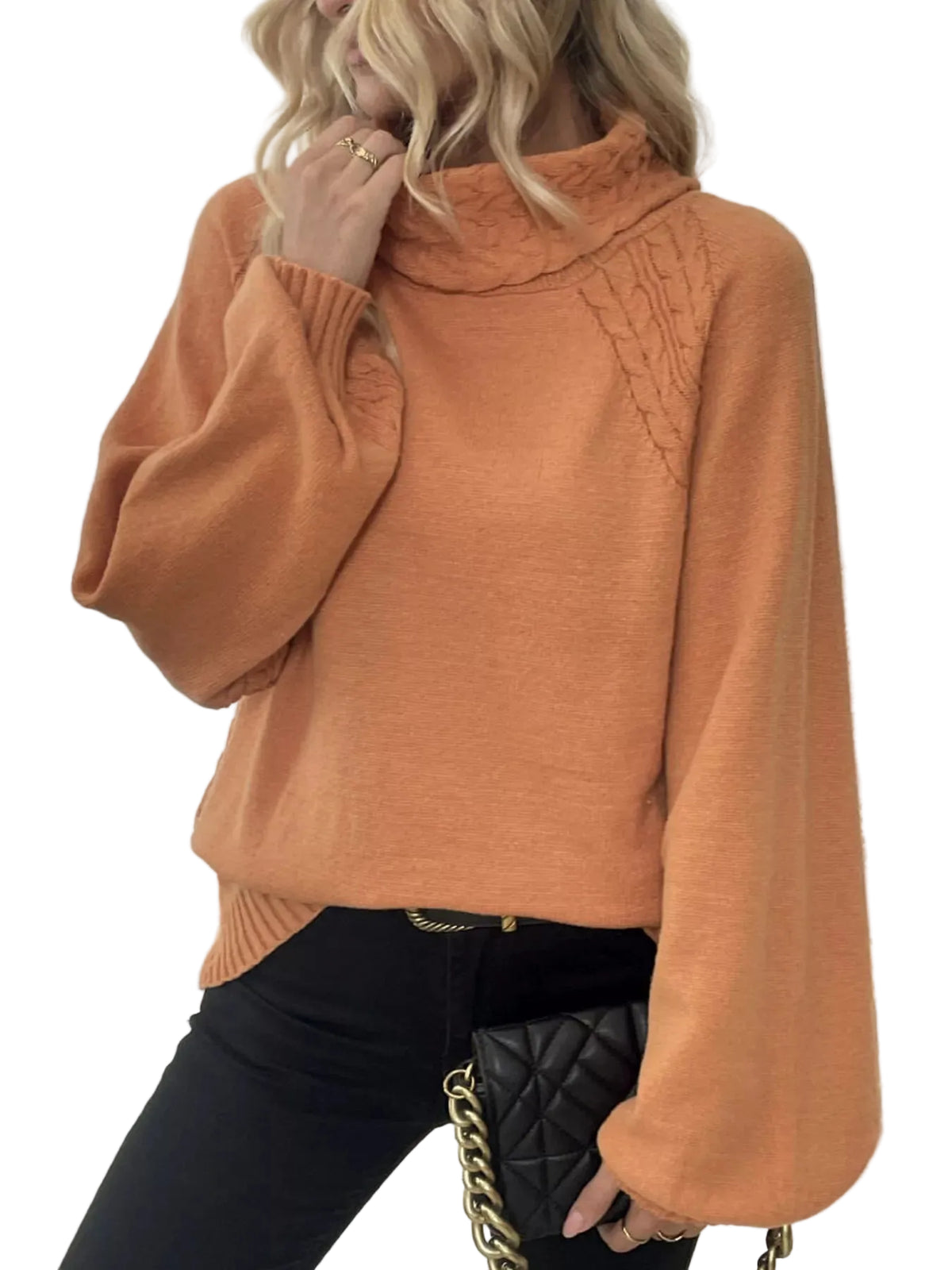Person wearing a brown sweater indoors with a blurred background