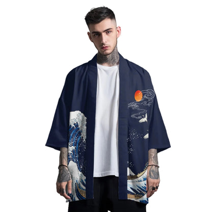 Man wearing a navy blue kimono with wave design over a white t-shirt on a gray background