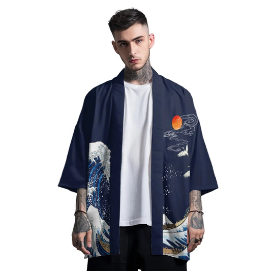 Man wearing a navy blue kimono with wave design over a white t-shirt on a gray background