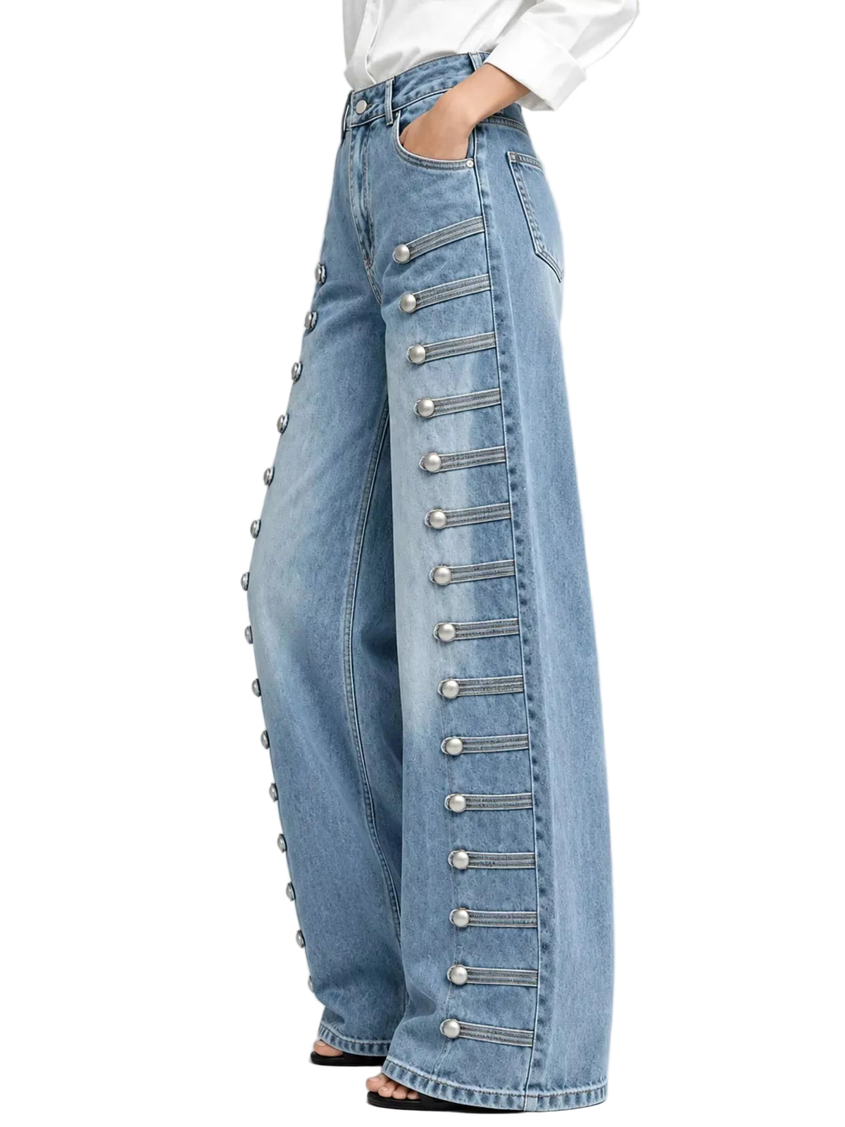 Light blue wide-leg denim jeans with decorative silver button and strap detailing down the outer side of each leg, shown on a model against a light gray studio background.