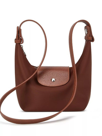 A brown leather shoulder bag with a curved hobo silhouette, a front flap pocket with a silver-tone snap button, and a long adjustable shoulder strap, shown on a plain white background.