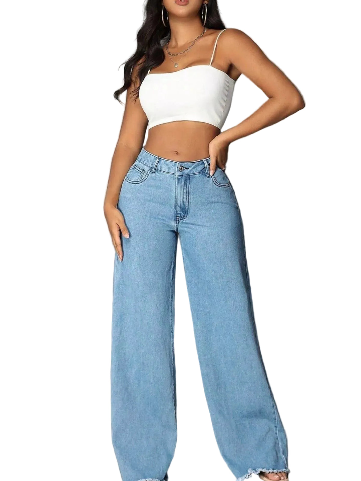 A woman modeling light-wash wide-leg denim jeans and a white crop top against a gray concrete wall.