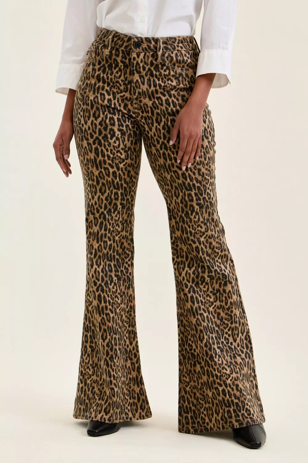 Leopard print flared pants worn by a person on a white background