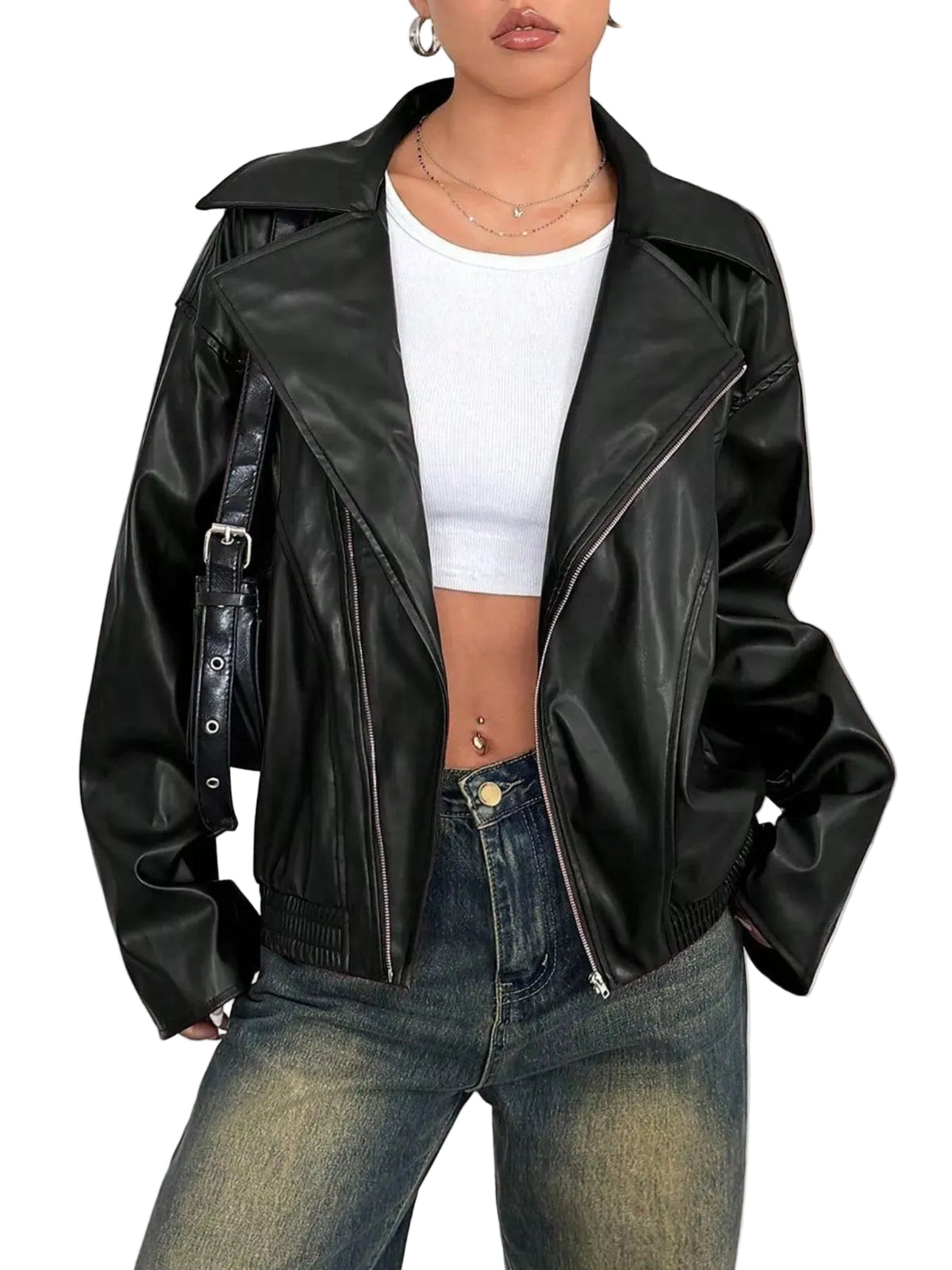 A woman wearing a black faux-leather moto jacket with silver zippers, styled over a white crop top and blue jeans.