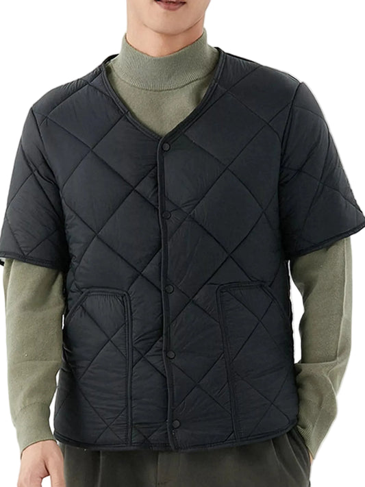 A man wearing a black quilted short-sleeve puffer vest over an olive green turtleneck sweater, shown from the neck down against a plain light background.