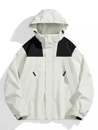 A hooded colorblock jacket in off-white and black, displayed flat against a white background with soft shadows.