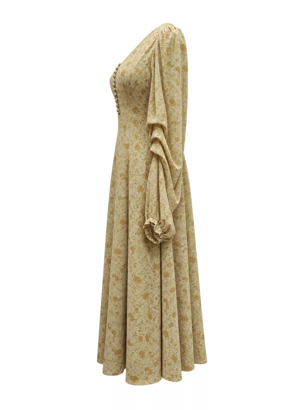 A long, one-shoulder midi dress in a beige and brown floral pattern, featuring a structured bodice with decorative buttons and a dramatic draped ruffle on the sleeve, shown against a plain white background.