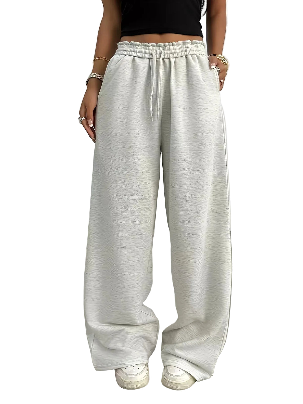 Person wearing light gray wide-leg pants with a blurred background