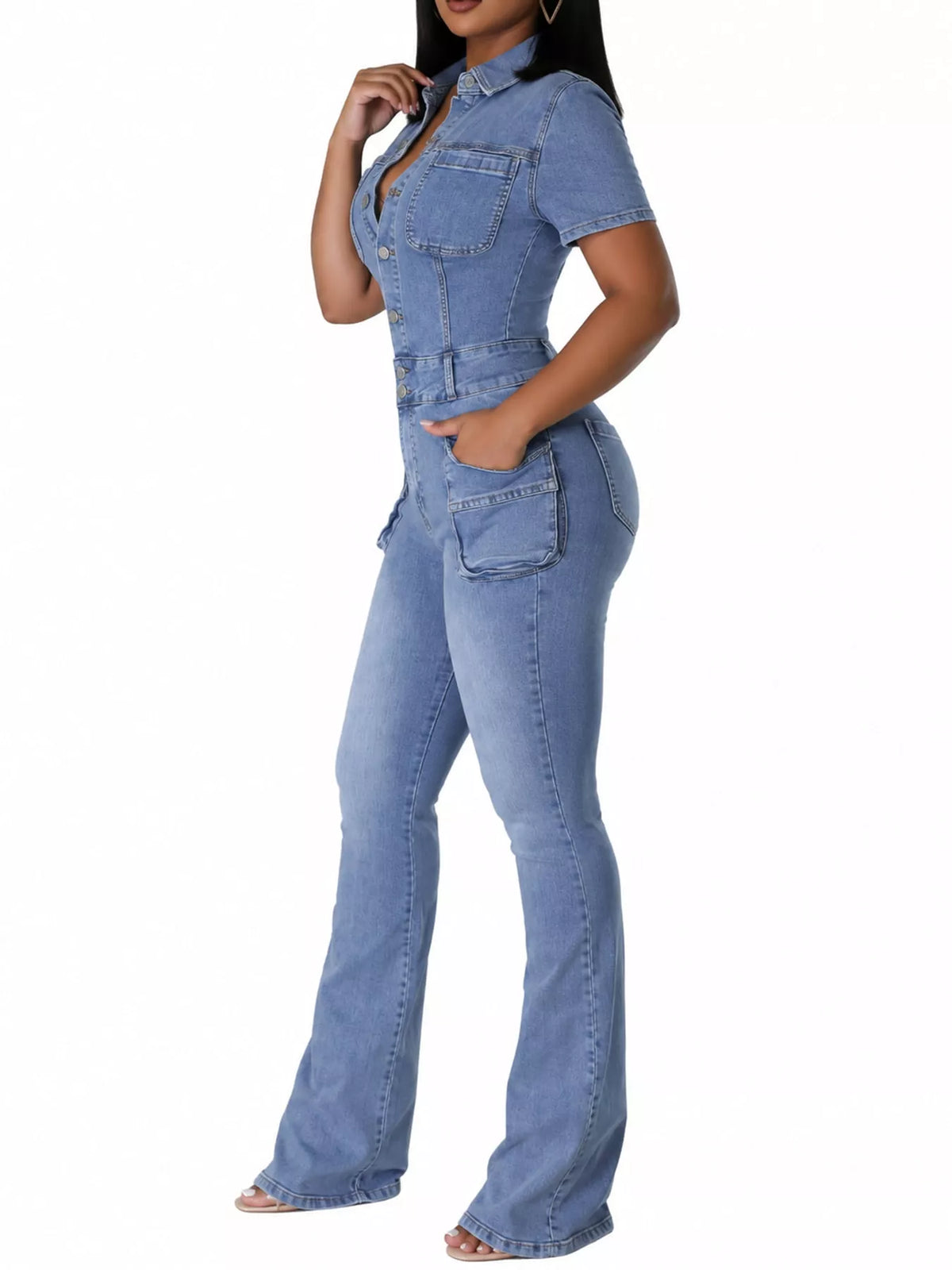 A woman modeling a light blue denim one-piece jumpsuit with short sleeves, a buttoned chest, and wide-leg flared pants, shown against a plain white background.