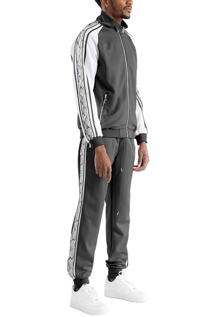 Man wearing a gray tracksuit with white stripes on a white background