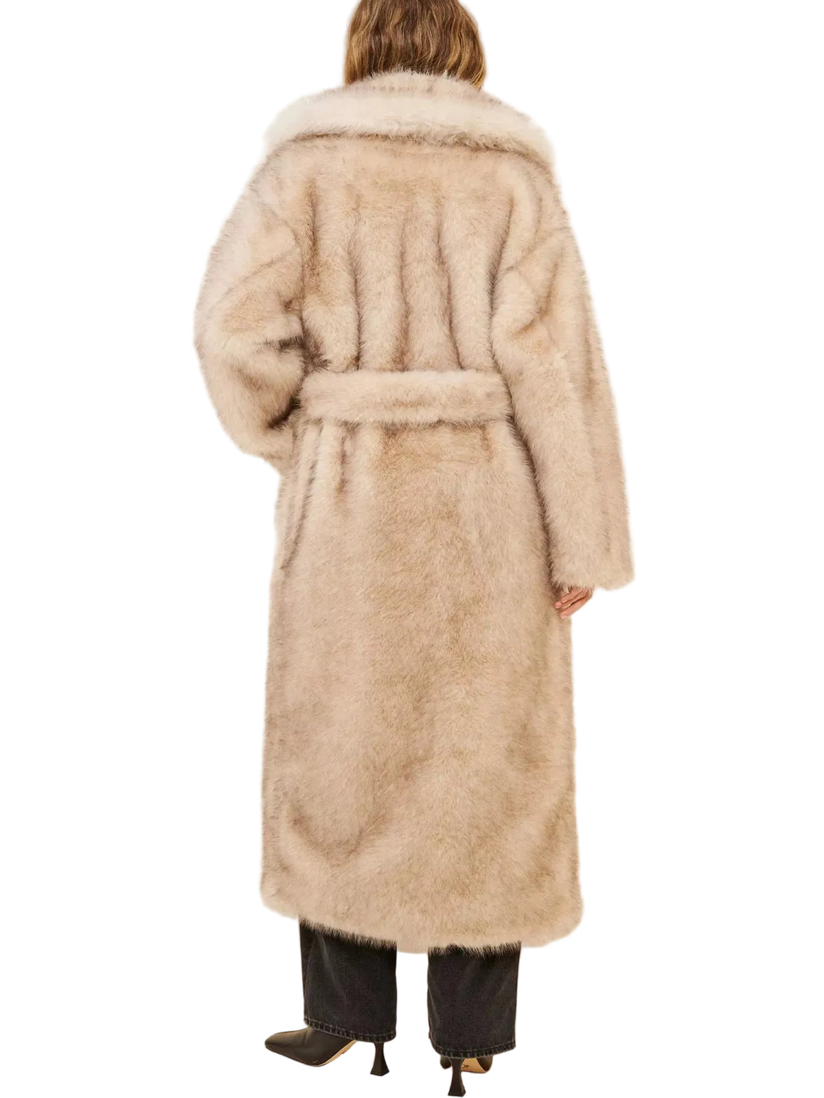 A model viewed from behind wearing a long, plush faux fur coat in a light beige color, paired with black pants and black heels, against a plain off-white background.