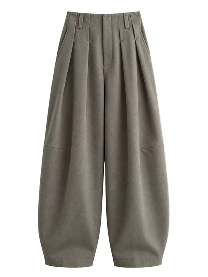 A pair of wide-leg, pleated trousers in a muted olive-gray color, displayed flat against a light off-white background.