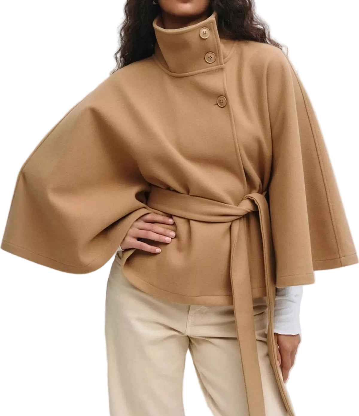 A woman wearing a camel-colored cape-style jacket with a high mock neck, wide sleeves, and a matching waist tie, paired with beige trousers.