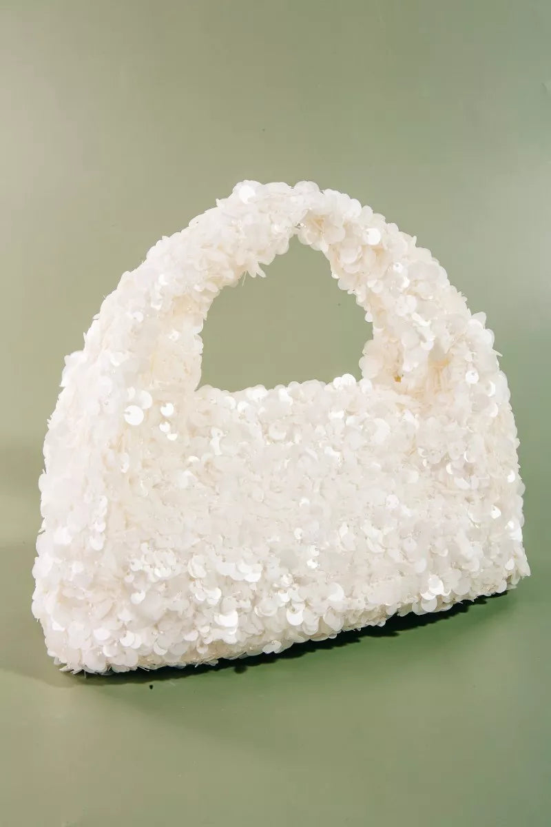 White textured handbag on a light green background