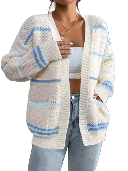 Person wearing a white and blue striped cardigan against a light background