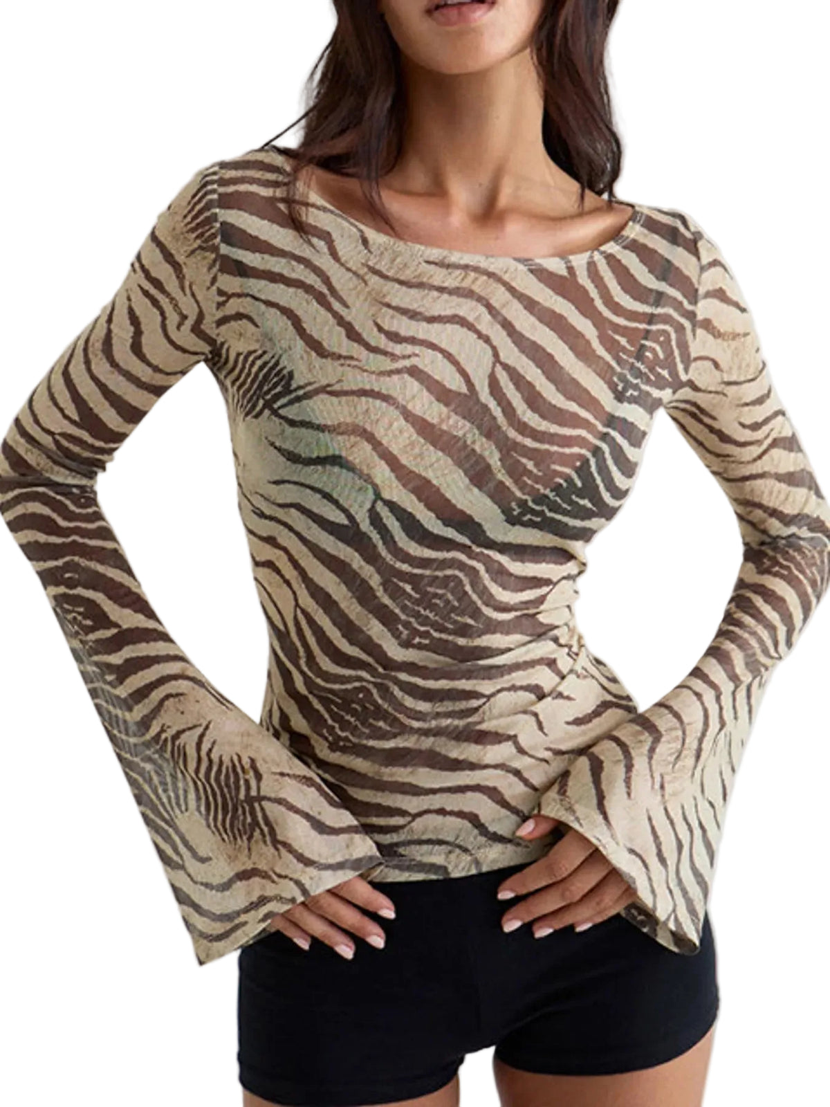 A woman wearing a beige and brown zebra-print long-sleeve top with flared bell sleeves, paired with black shorts, against a light gray studio background.
