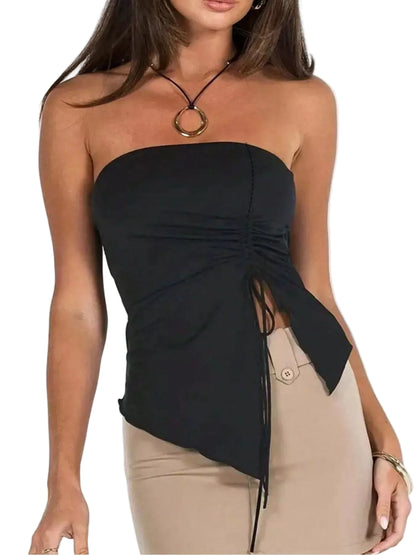 A woman wearing a black strapless ruched tube top with an asymmetrical tie detail and beige pants, shown against a plain white background.