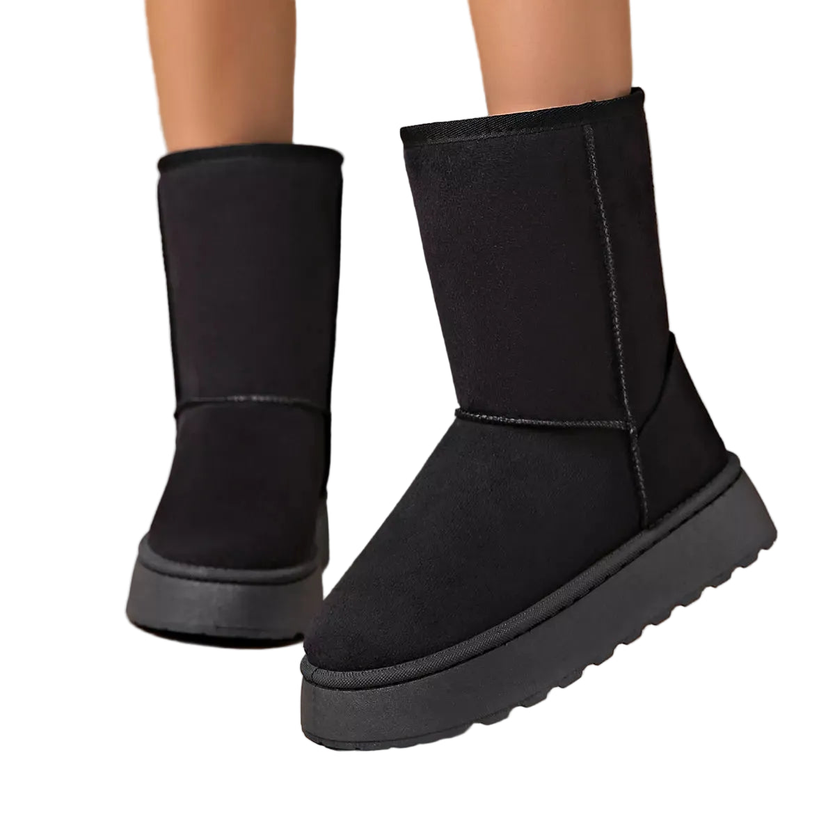 A pair of black mid-calf platform boots with a thick lug sole, shown on a model's feet against a minimalist beige background.