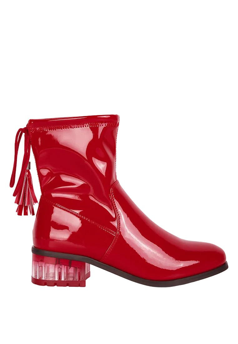 Shiny red ankle boot with clear block heel on a white background