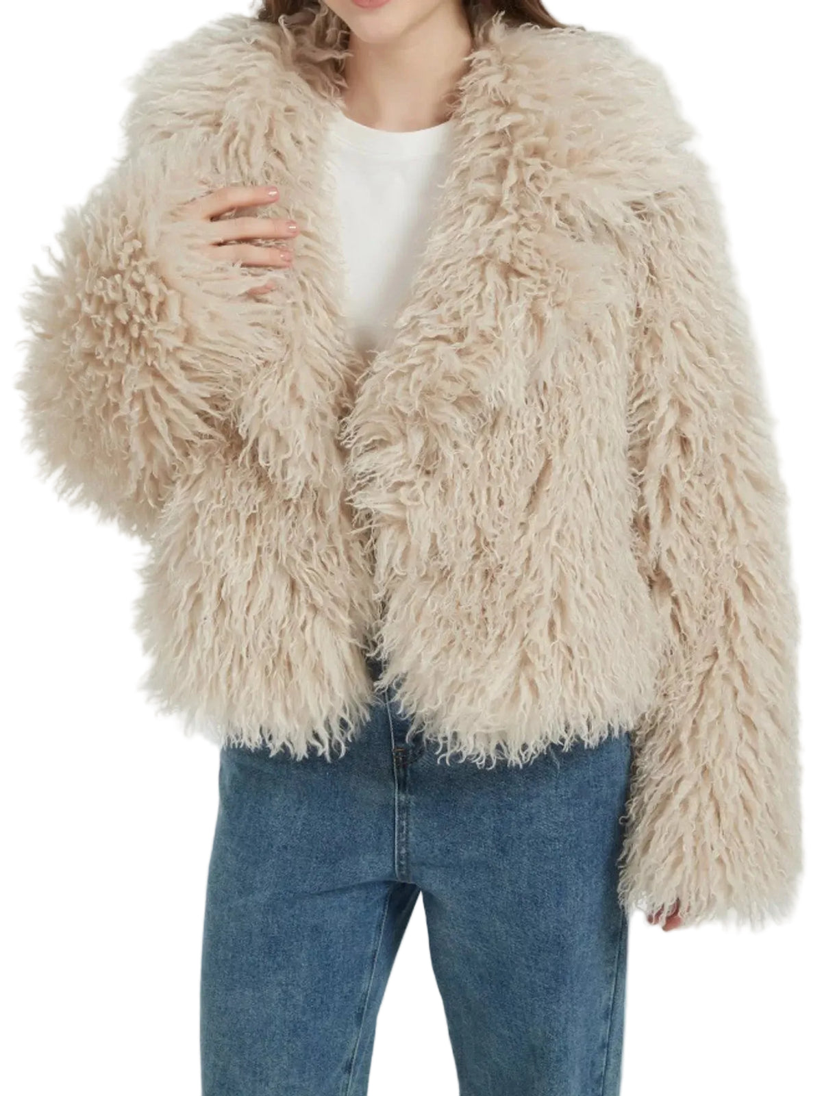 A person wearing a shaggy, long-pile faux fur jacket in a light beige or cream color, styled over a white top and blue jeans against a plain light background.