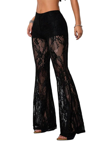 Black lace flare pants with a solid black waistband, modeled against a light gray wall.