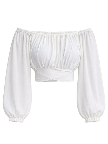 A white off-the-shoulder long-sleeve crop top with a gathered bust and elasticized cuffs, shown against a solid light beige background.