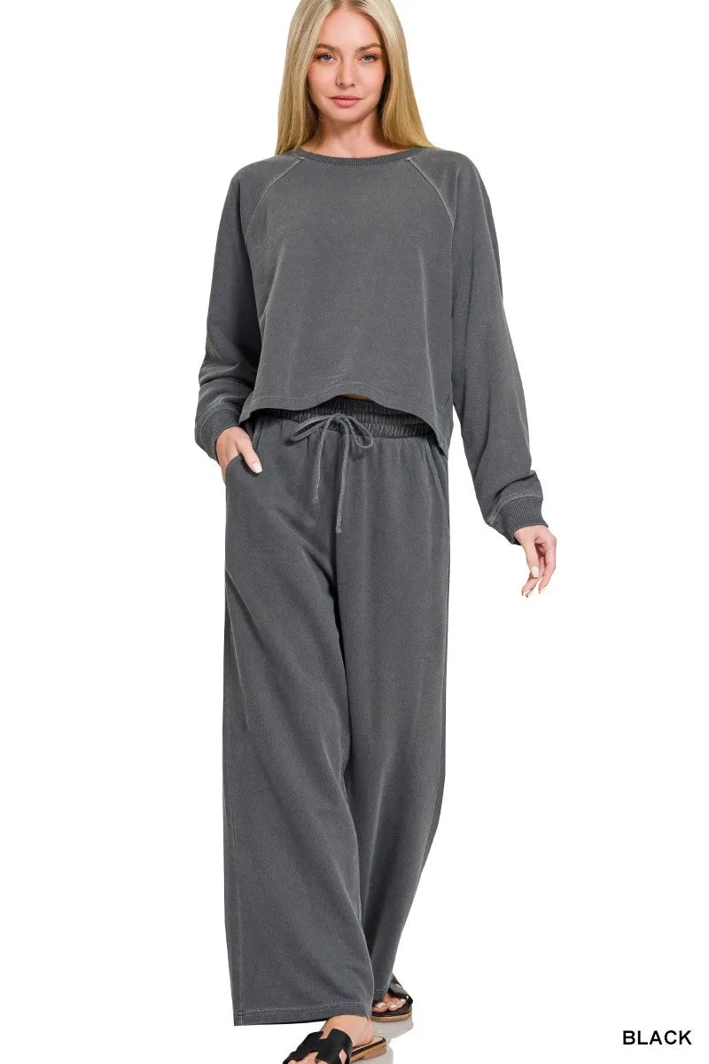 Woman wearing a gray lounge set on a white background