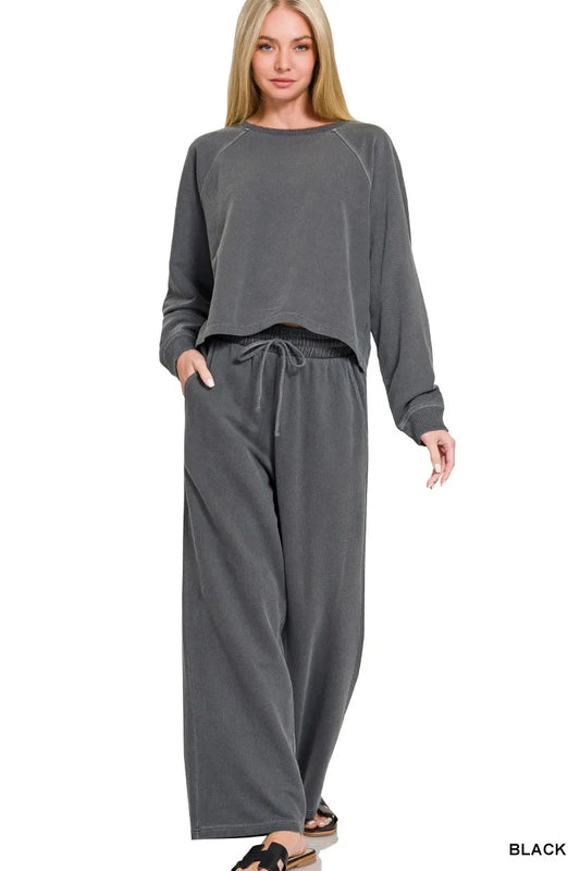 Woman wearing a gray lounge set on a white background