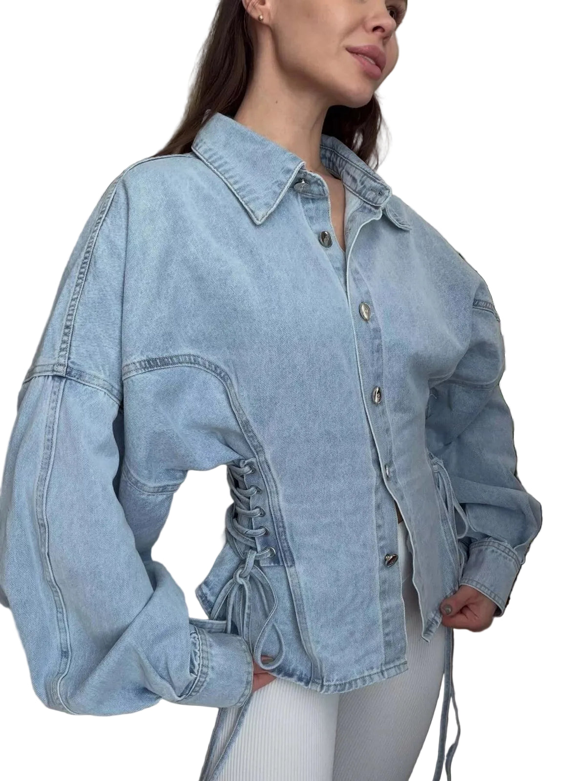 Light blue denim jacket with corset-style lacing worn by a person indoors.