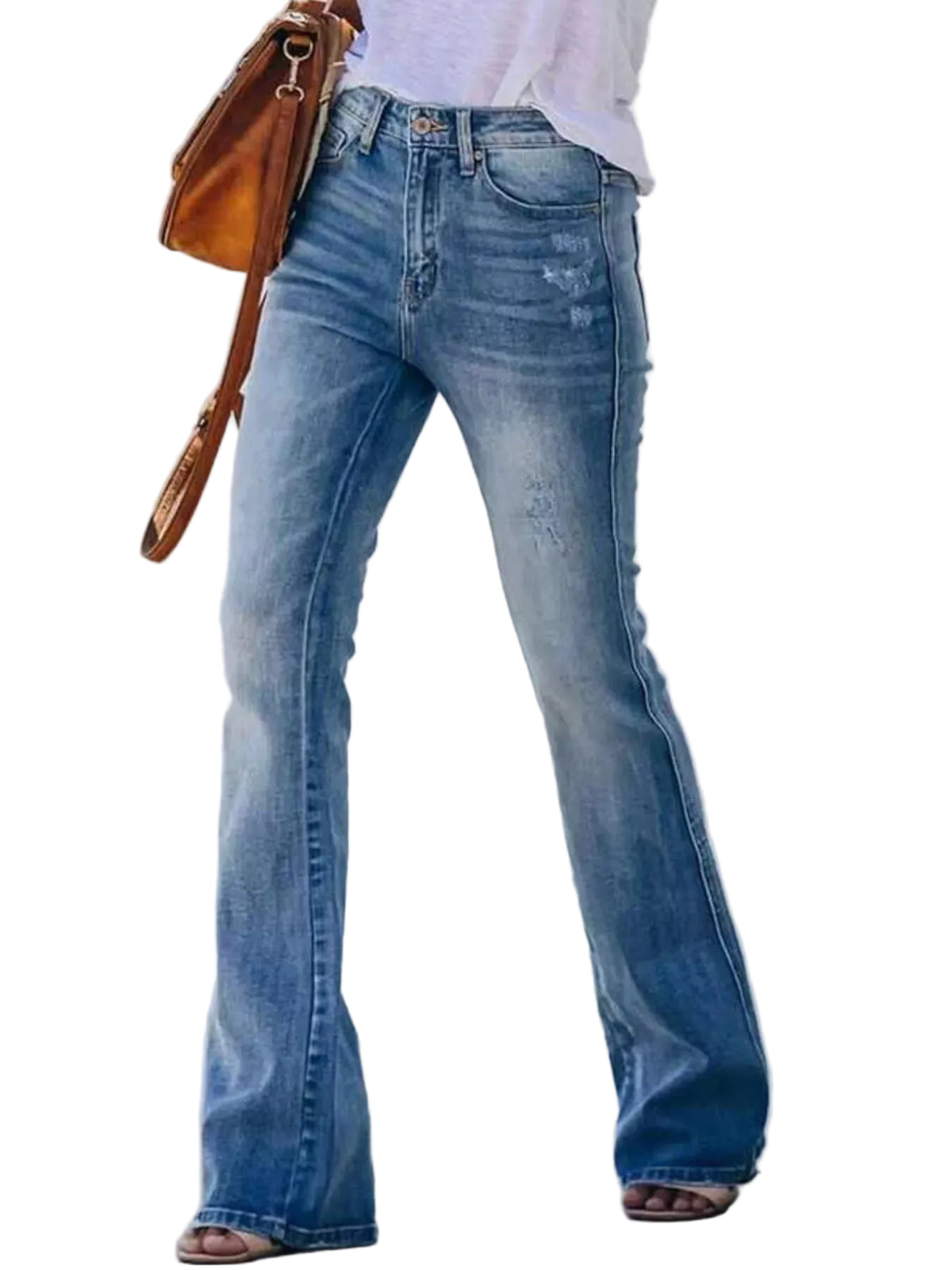 A person wearing light-wash blue flare jeans with a white top, carrying a brown shoulder bag, standing against a white wall.