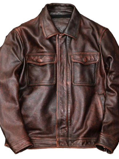 A dark brown distressed leather jacket with a pointed collar, front button closure, and two buttoned chest flap pockets, displayed against a textured gray background.