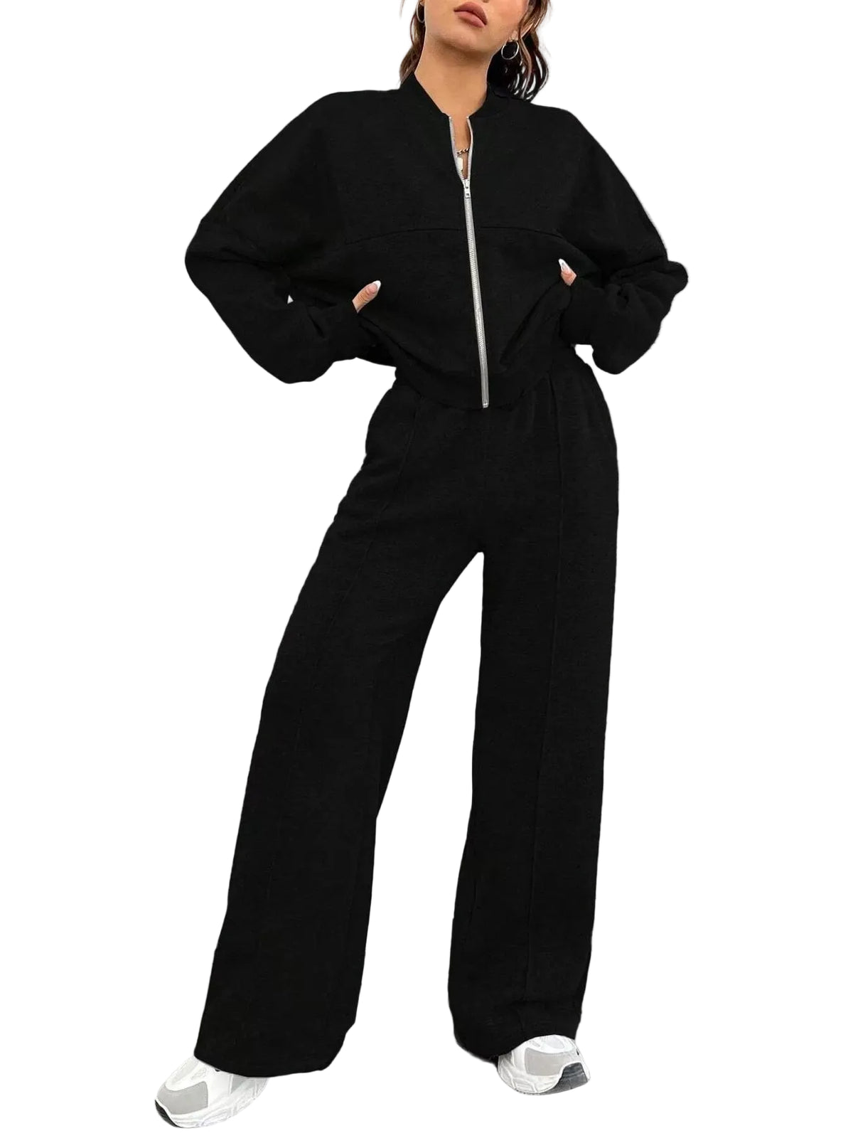 Person wearing a black outfit with wide-leg pants against a white background