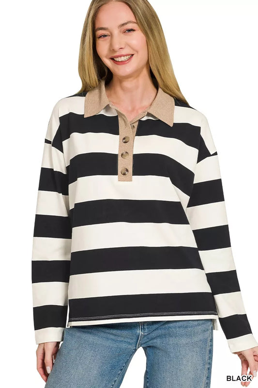 Woman wearing a black and white striped long-sleeve shirt with a collar.