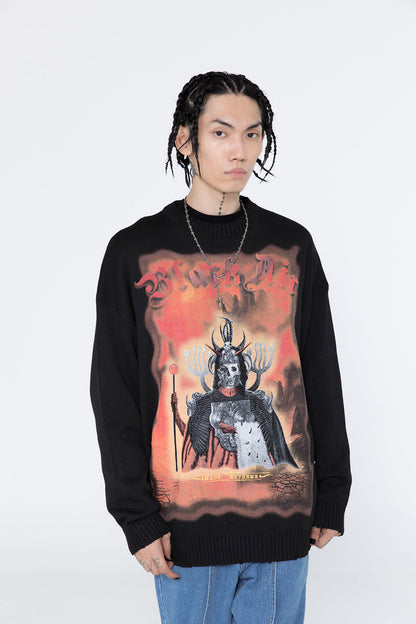 Person wearing a black sweater with a graphic design on a white background