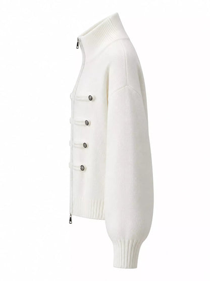 An off-white knit zip-up cardigan sweater with a mock neck, ribbed cuffs, and decorative silver snap buttons on the front, shown from a side profile view against a plain white background.