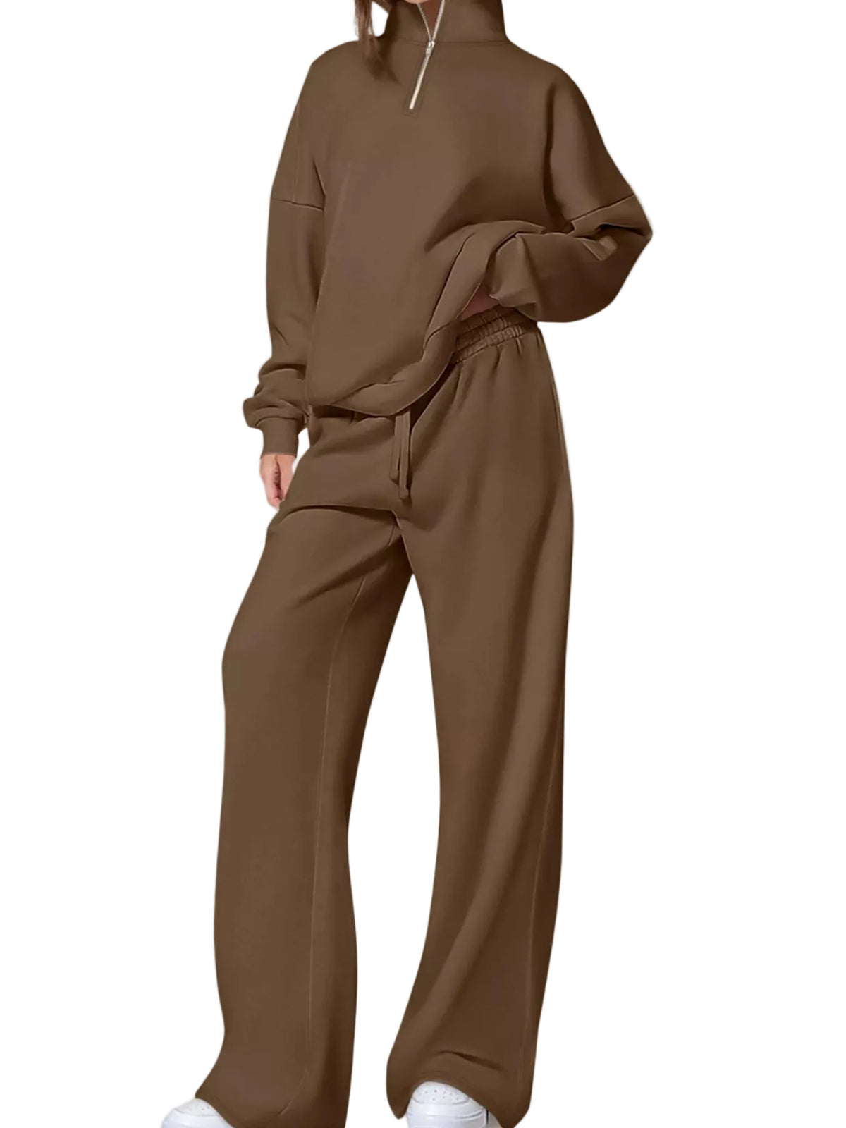 A model wearing a matching brown two-piece lounge set consisting of a half-zip mock-neck sweatshirt and wide-leg sweatpants, photographed against a neutral studio background.