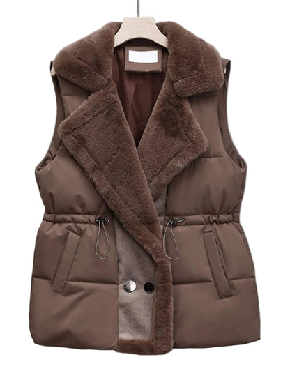A brown puffer vest with a plush faux-fur collar and lapel, featuring a drawstring waist and front snap buttons, displayed on a hanger against a gray background.