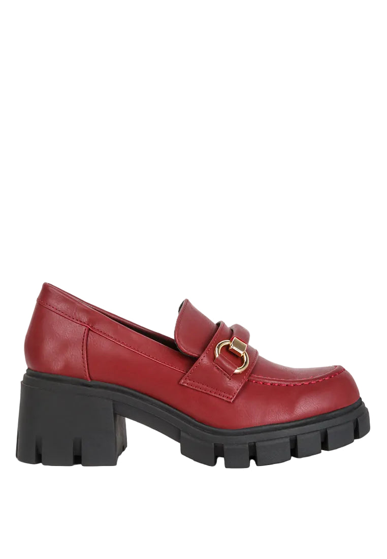 Red loafer shoe with a gold buckle on a white background