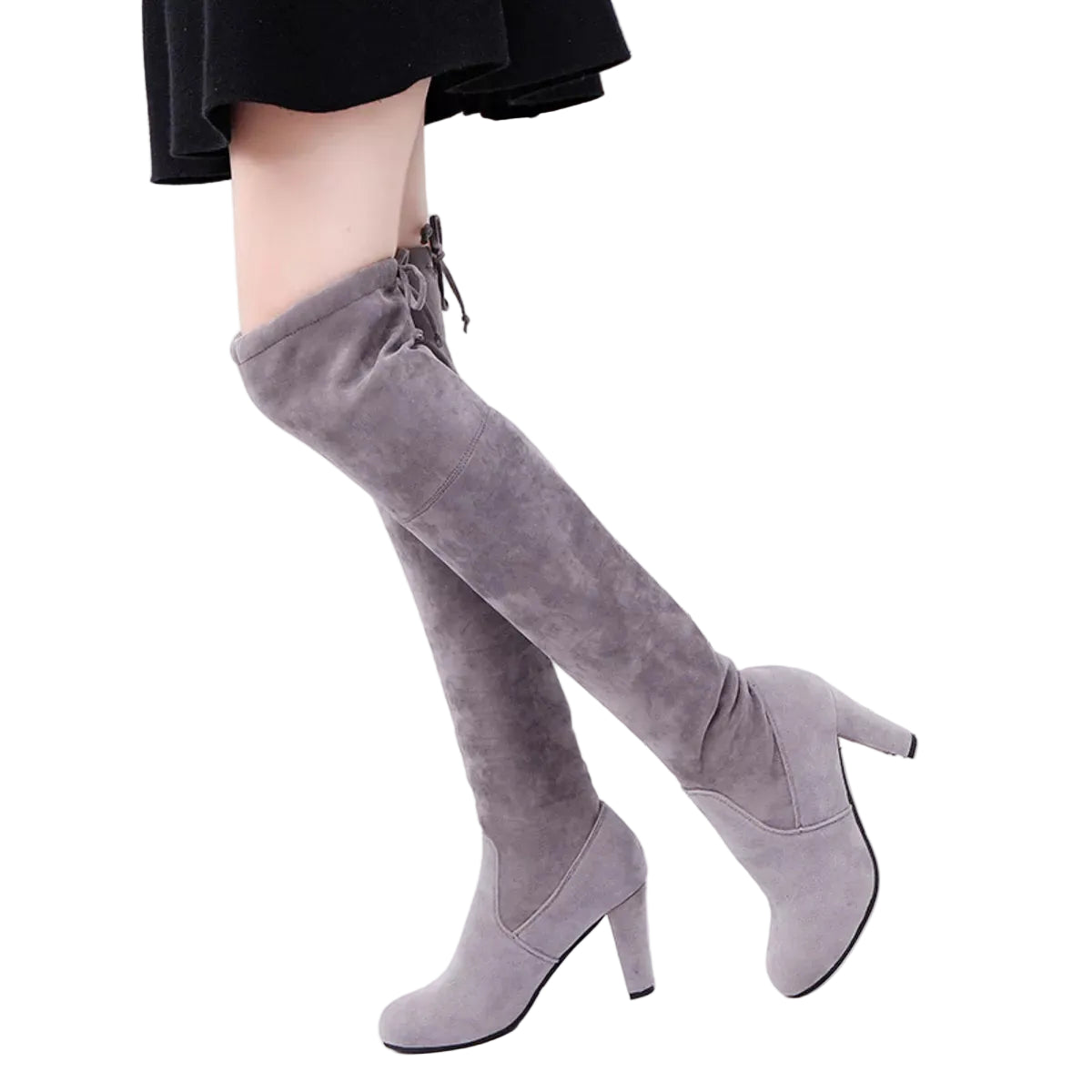 Gray knee-high boots worn with a black skirt against a white background